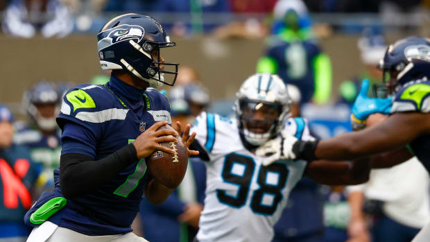Seattle Seahawks quarterback Geno Smith looks for an open receiver in a game against the Carolina Panthers. 